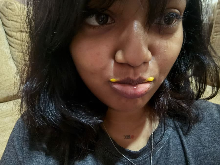 Anamika with a yellow moustache of snack crumbs